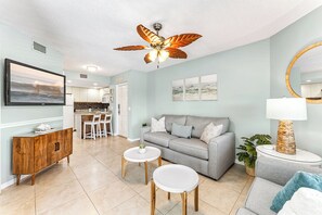 This spacious living room invites you to sink into plush seating, enjoy the coastal breeze, and gather with loved ones for unforgettable moments.