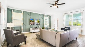 Bright modern living room with comfy seating, smart TV, stylish decor and light vibes
