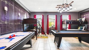 Magical game room with themed bunk beds, pool table, air hockey and fun decor
