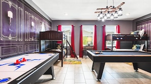 Magical game room with themed bunk beds, pool table, air hockey and fun decor