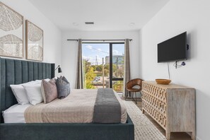 Comfortable queen bed in this bedroom with a Smart TV and room darkening shades. Plenty of storage space for your clothes.