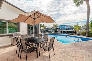 Outdoor dining area, with gas BBQ and cooler. Enjoy a day by the pool BBQ with family.