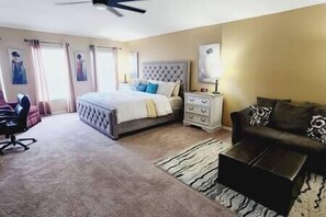 Spacious master suite with king bed, love seat, recliner and desk.