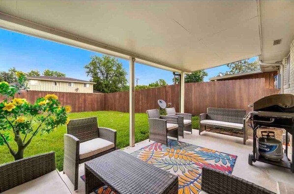 Unit 1: Covered back patio with outdoor seating for 8.  Propane grill with utensils is provided.