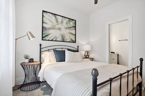 Relax in a queen bed, natural lighting, black out curtains, & USB/Bluetooth alarm clock