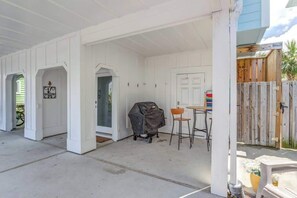 Front Door Patio with Grill, outdoor shower,  Garden hose, and gate to back yard.