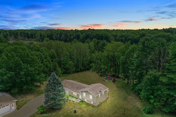 Exterior Retreat: Nestled among lush trees, enjoy nature's embrace and vibrant sunsets!
