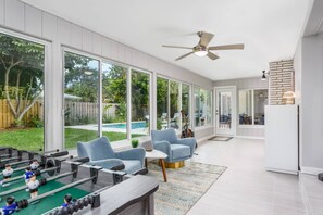 Game room off the living room with views of the backyard and swimming pool