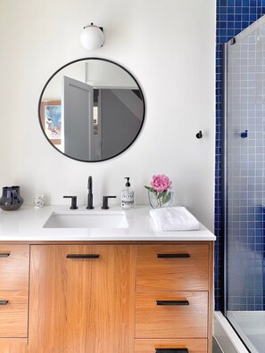 3/4 Bathroom off the hallway with marine blue Japanese tile.
