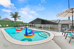 The spacious veranda with a pool, spa, loungers, dining area, and BBQ is where all the fun happens!