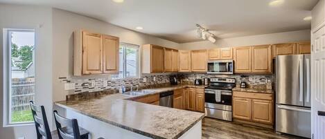 Experience the convenience of a well-stocked kitchen, equipped with modern appliances and tools