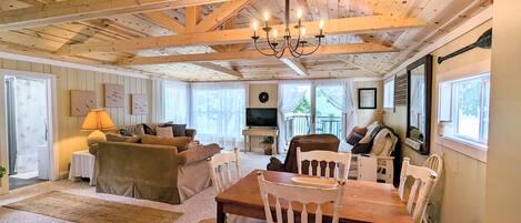 Comfy seating and large picture windows allow for a great view of the lake from inside too! The beautiful vaulted wood ceiling gives that cozy cabin feel.