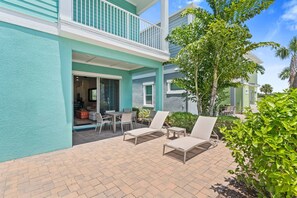 Refreshing outdoor area of the townhouse in Reunion Florida - Lounge chairs for relaxation - Relax and unwind in serene setting - Find tranquility surrounded by greenery and nature