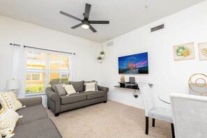 The sitting area has a wall-mounted Smart TV