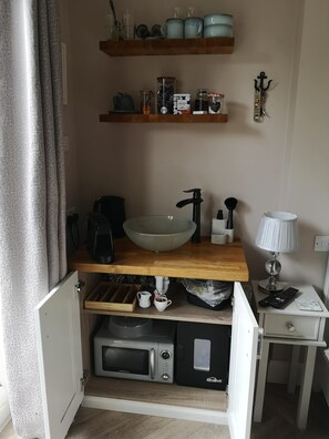 Small Kitchen area with microwave, coffee machine, kettle, micro fridge and sink