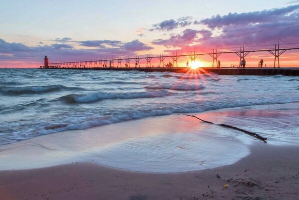 Beautiful sandy beach of Lake Michigan with iconic red lighthouse. Just a short stroll from our home!