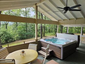 Large porch with hot tub and outdoor dining