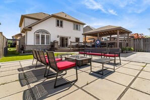 Enjoy relaxing in the backyard oasis with fire pit, BBQ and lots of seating!