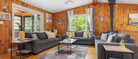 Upper level living room with ample seating, smart tv, wood burning fireplace, boardgames and fabulous views.