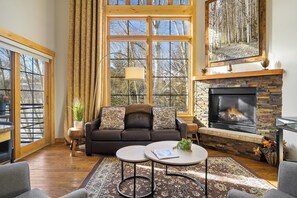 Main level living area with floor to ceiling windows