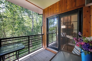 Sliding glass doors from living area lead out to the main level balcony