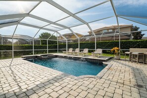 Beautiful paver stone lined deck with pool and spa.