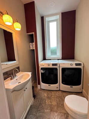 Half bath including washer and dryer.