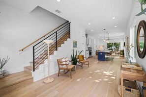 Foyer leading into kitchen and upstairs