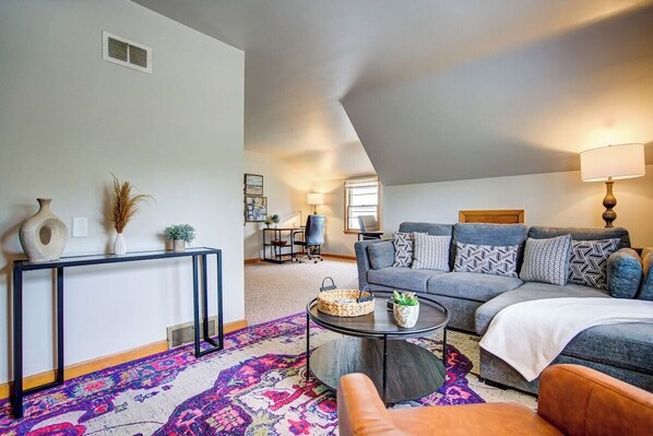 Living room with sectional sleeper sofa and 65" Roku Smart TV!