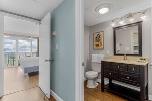 Conveniently designed ensuite with a stylish vanity and a calming ambiance. Enjoy the seamless connection to your cozy bedroom with stunning ocean views just steps away.