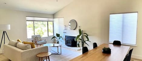 Front living/dining room with cathedral ceiling and hills views