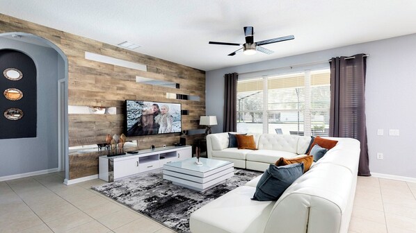 Spacious modern living room area with cozy sofa, perfect for family reunion