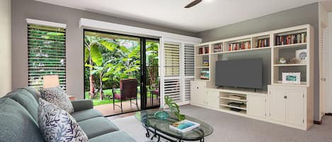 Seamless indoor-outdoor living: a spacious living area seamlessly connects to the lanai, inviting the outdoors in.