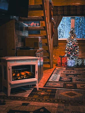 Electric fire place in living of this log cabin