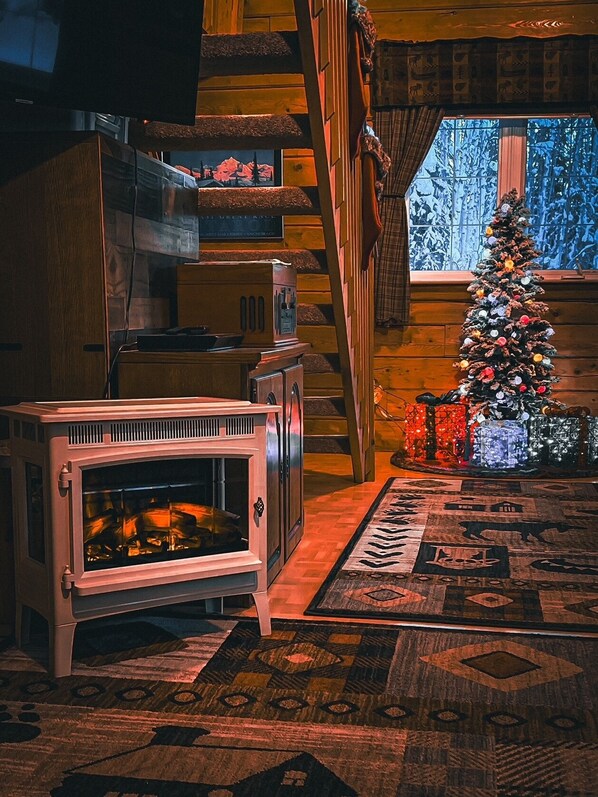 Electric fire place in living of this log cabin