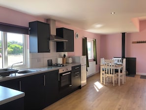 Well equipped kitchen with dining table for four.