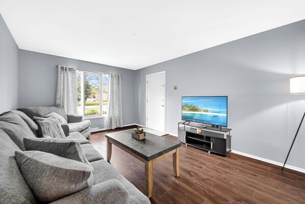 Living room with brand new couch and over sized chair (1)