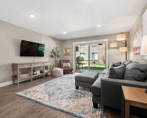 Living room with patio access and 60" smart TV