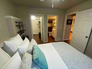 Queen sized bed, full bathroom, and closet