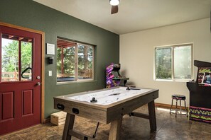 Unleash your competitive side in this arcade-style game room with air hockey, Street Fighter & Teenage Mutant Ninja Turtles!