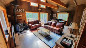 Upper level living area with wood stove, TV and walkout slider
