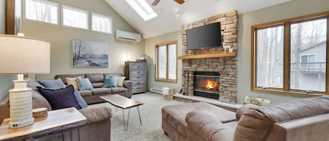 High ceilings courtesy of chalet living, view of den from eat-in kitchen