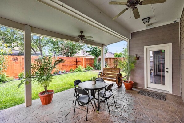 View of the covered patio and seating area facing towards the backyard.