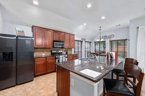 Fully stocked kitchen with plenty of counter space and cabinets. The fridge, oven, microwave, and stove are all included. The cabinets include pots & pans, plates, glassware, and more.