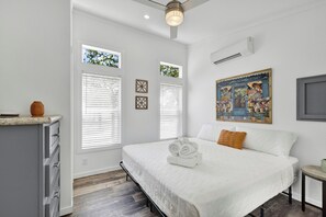 The spacious bedroom is adorned with a king bed, inviting comfort and restful nights.