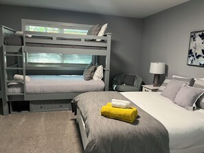  Bedroom #1 with a queen size adjustable bed and remote control and bunkbed