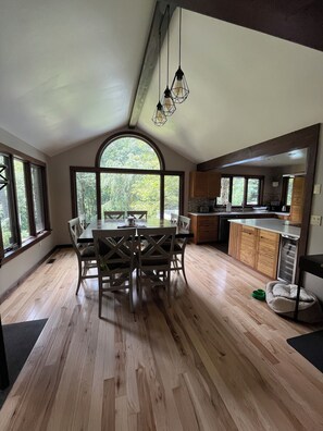 Open living room with wood table that sits 8 people