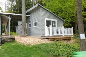 Separate cottage with king bed, en suite bath, and private deck facing lake.