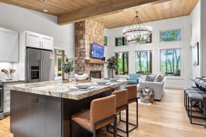 Main level open concept oversized kitchen island and living room