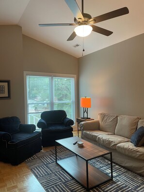 Living room with games, 55" smart TV, fan and access to screened porch 